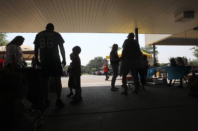People shop at a Pop Up Market outside of the Laskowski ACE Hardware store, in McHenry, on Friday, Aug.15, 2025, during McHenry.’ 815 Day.