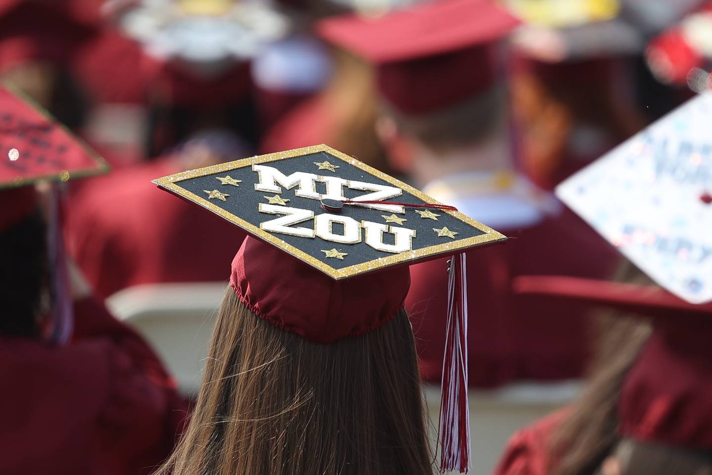 A graduate customizes their hat at the Plainfield North Class of 2023 Commencement Ceremony on Saturday, May 20, 2023, in Plainfield.