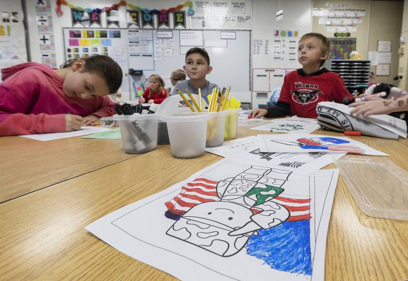 Students color in pictures for the Valor Support Project Monday, Nov. 10, 2025, at Merrill School in Rock Falls. The project helps raise money and awareness for veterans in need.