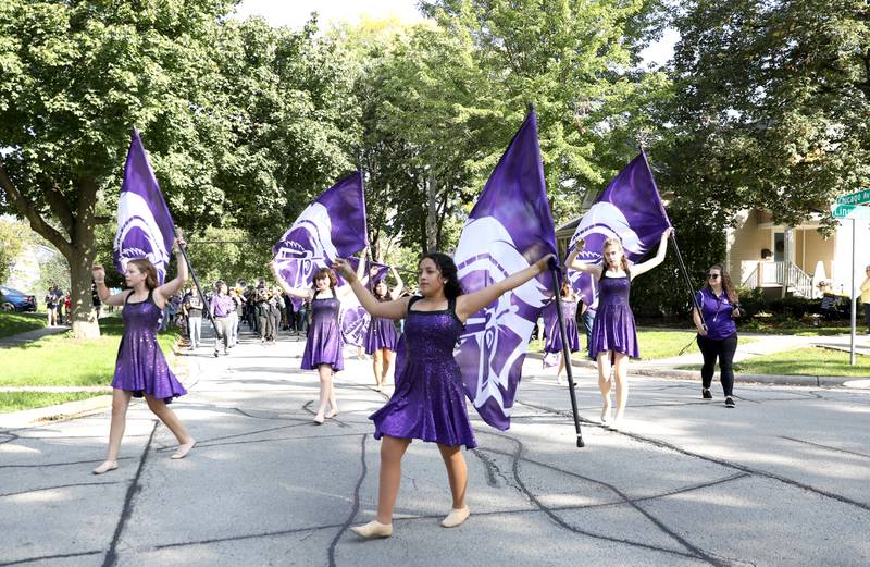 Members of the Downers Grove North High School color guard perform during the school’s annual homecoming parade on Friday, Sept. 29, 2023.