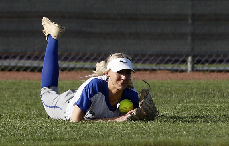 Burlington Central's Mia Lindquist makes a diving catch to end the inning during a Fox Valley Conference softball game against Hampshire on Tuesday, April 21, 2026, at Hampshire High School.