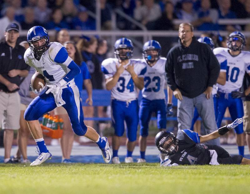 Geneva's defensive back Pace Temple (4) intercepts a St. Charles North pass for a score Friday at St. Charles North High School in St. Charles.