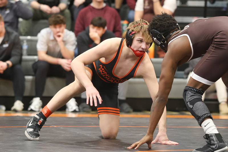 Minooka’s Maddux Tindal faces off with Joliet Catholic’s Jason Hampton in the Class 3A Minooka Regional 132 pound championship  match on Saturday, Jan. 31, 2026 in Minooka.