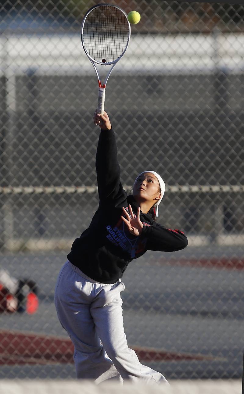 Marian Central’s Jordan Cheng serves the ball Thursday, Oct. 23, 2025, during the first day of the IHSA State Girls Tennis Tournament at Schaumburg High School.