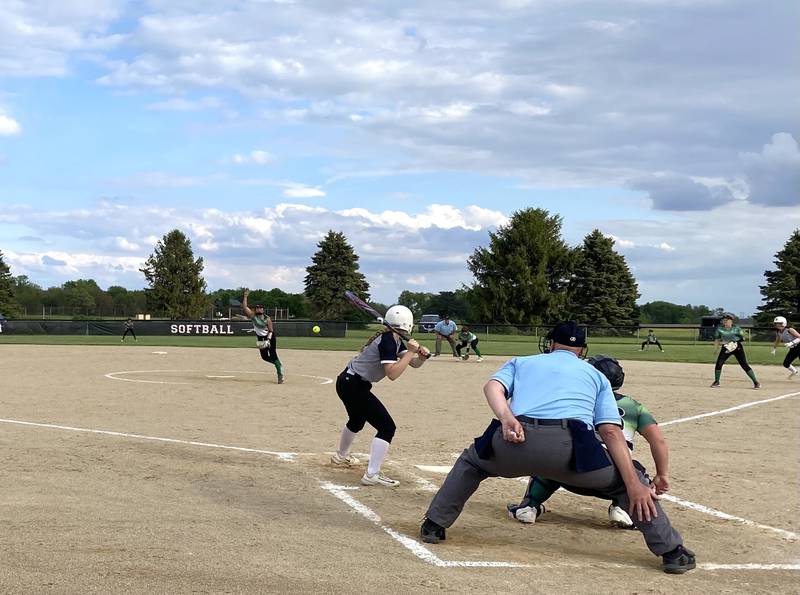 Woodland/Flanagan-Cornell cleanup hitter Ella Derossett stands ready as the Dwight battery of pitcher Madi Ely and catcher Avery Scheuer execute a pitch-and-catch Monday, May 6, 2024, at Woodland School in rural Streator.