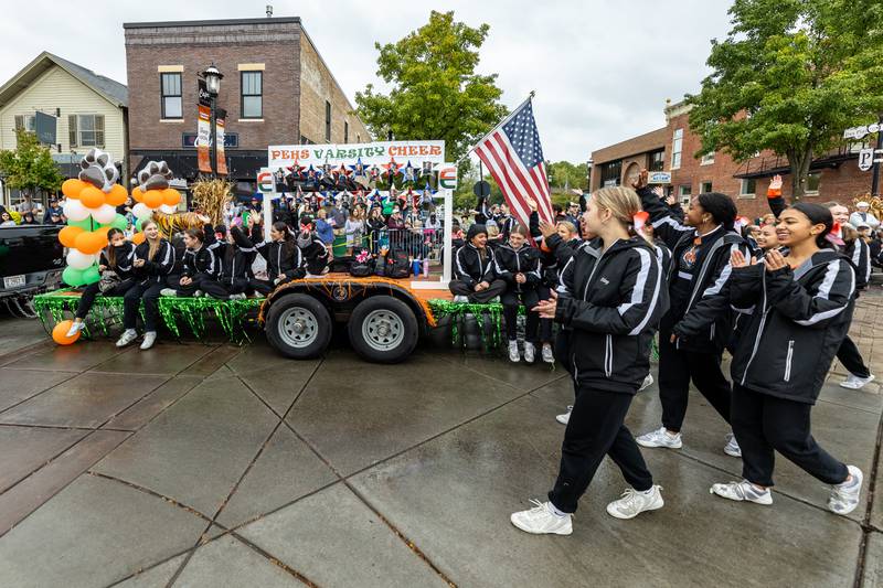 The Plainfield East High School Varsity Cheer Team participates shares school spirit during the Plainfield Community Homecoming Parade on Sept. 28, 2024. (Laurie Fanelli for Shaw Local News Network)