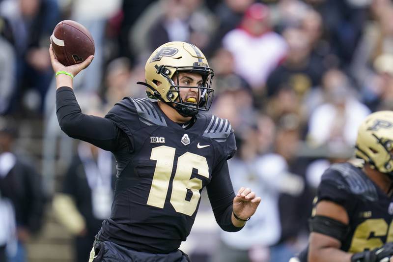 FILE - Purdue quarterback Aidan O'Connell (16) throws a pass against Wisconsin during the first half of an NCAA college football game in West Lafayette, Ind., Saturday, Oct. 23, 2021.  Penn State thinks it can unseat Ohio State and Michigan as the top team in the Big Ten East. Purdue believes it can win the wide open Big Ten West. Thursday night's season opener could play a big part in what happens next. (AP Photo/Michael Conroy, File)