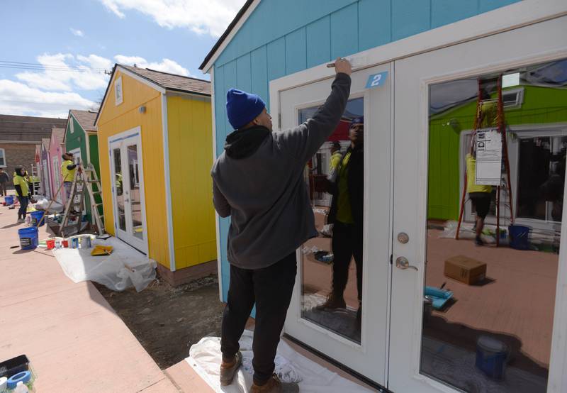 Sherwin Williams  employees including Xavier Martinez of Chicago help paint the Berwyn pop up shops April 16.