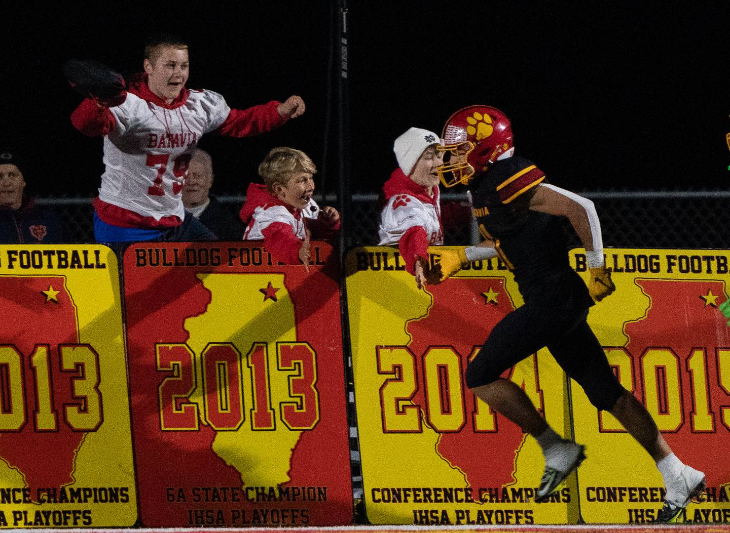 Batavia’s Gerke Drew (11) high fives fans after scoring a touchdown against Geneva during a football game at Batavia High School on Friday, Oct 7, 2022.