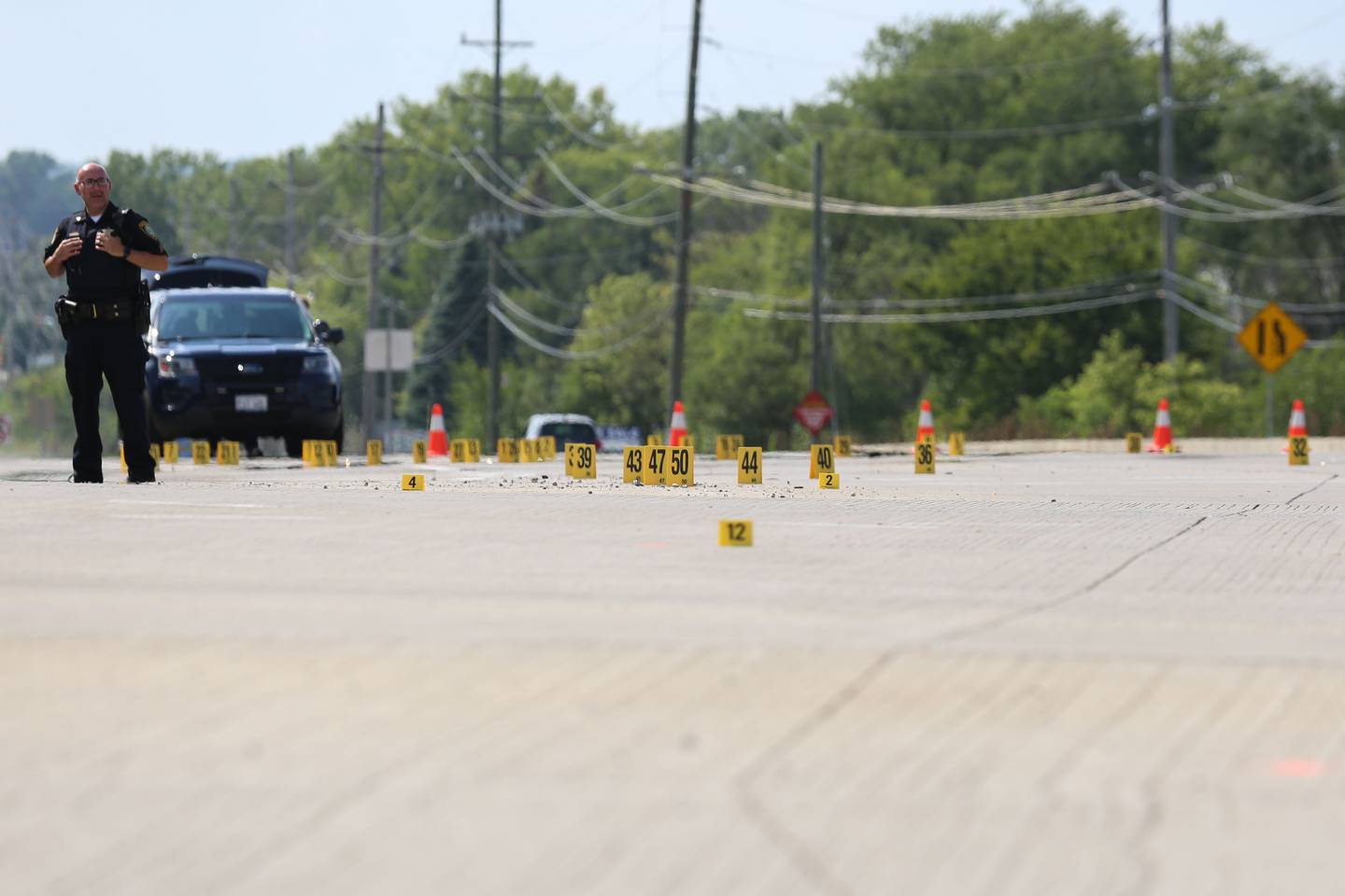 Dozens of yellow evidence markers were placed in the intersection of Illinois Route 31 and Bull Valley Road in McHenry after officers responded to a report of shots fired in the area Sunday, Aug. 29, 2021.