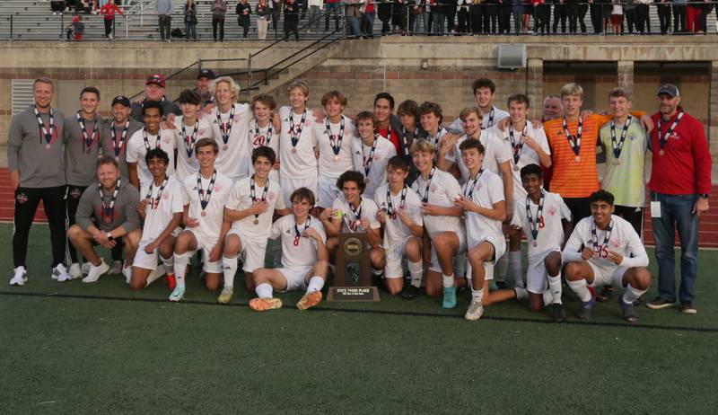 Members of the Timothy Christian soccer team pose for a photo with their Class 1A State soccer third place trophy after defeating Wheaton Academy on Saturday, Oct. 29, 2022 at EastSide Centre in Peoria.