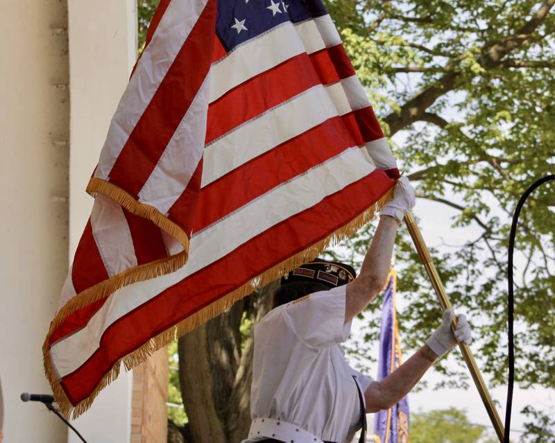 Sterling American Legion Post 296 Commander Susan Foss places the United States flag in its stand during a Memorial Day observance on Monday, May 29, 2023 at Grandon Civic Center in Sterling.
