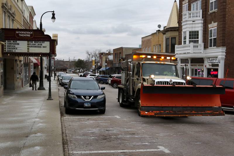 Road salt is applied to Main Street on Wednesday, Feb. 5, 2025, in Woodstock, in preparation for a winter storm,