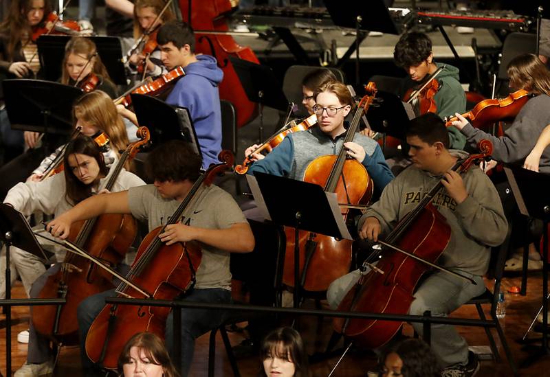Members of the Woodstock High School Orchestra perform “Unknown” composed by Woodstock High School graduate Alex Riak on Thursday, Dec. 7, 2023, during a rehearsal for the school's “Across the Universe” concert.