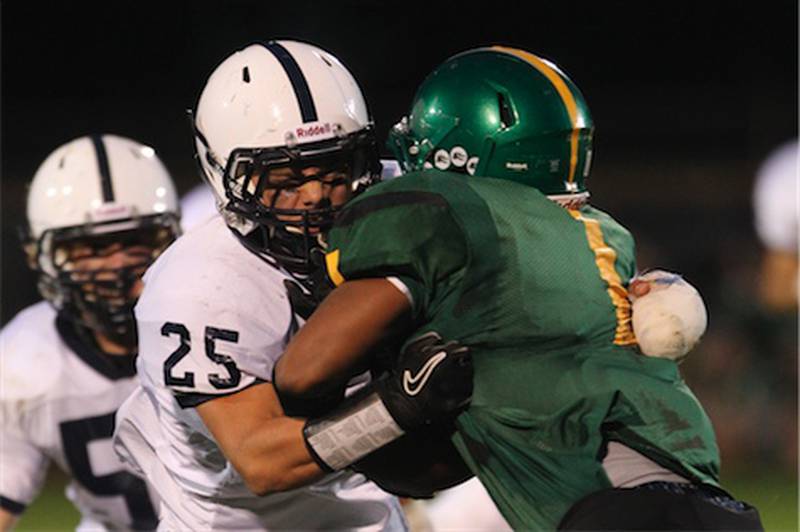 Cary-Grove defensive back Jakub Ksiazek wraps up Crystal Lake South running back Zevin Clark in the first quarter Friday at South. Cary-Grove won, 17-3.