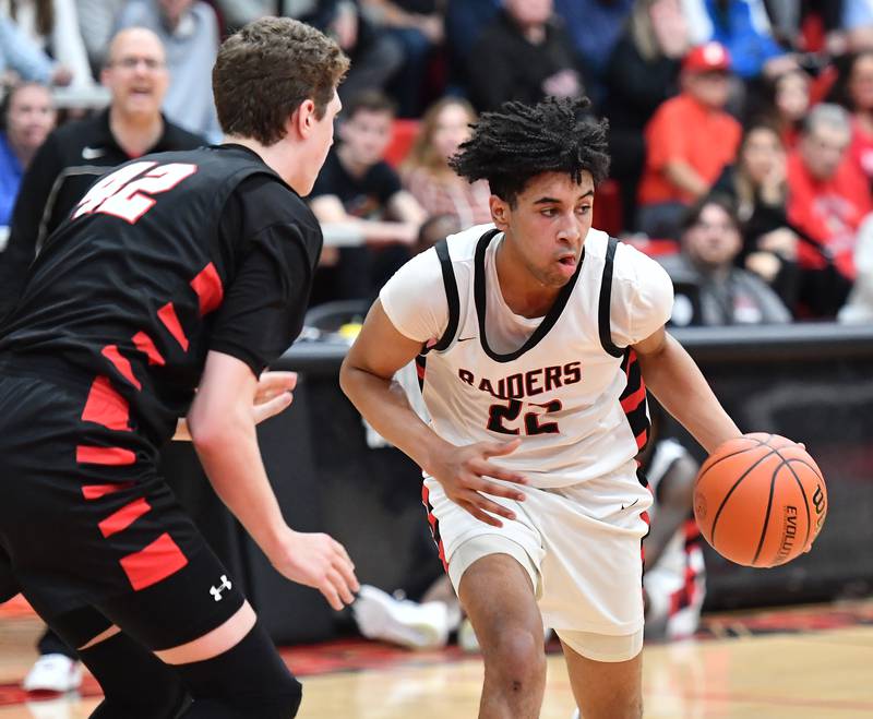 Bolingbrook's JT Pettigrew looks for an open teammate as Benet's Colin Stack defends during a Class 4A East Aurora Sectional semifinal game in February 2024 at East Aurora High School in Aurora.