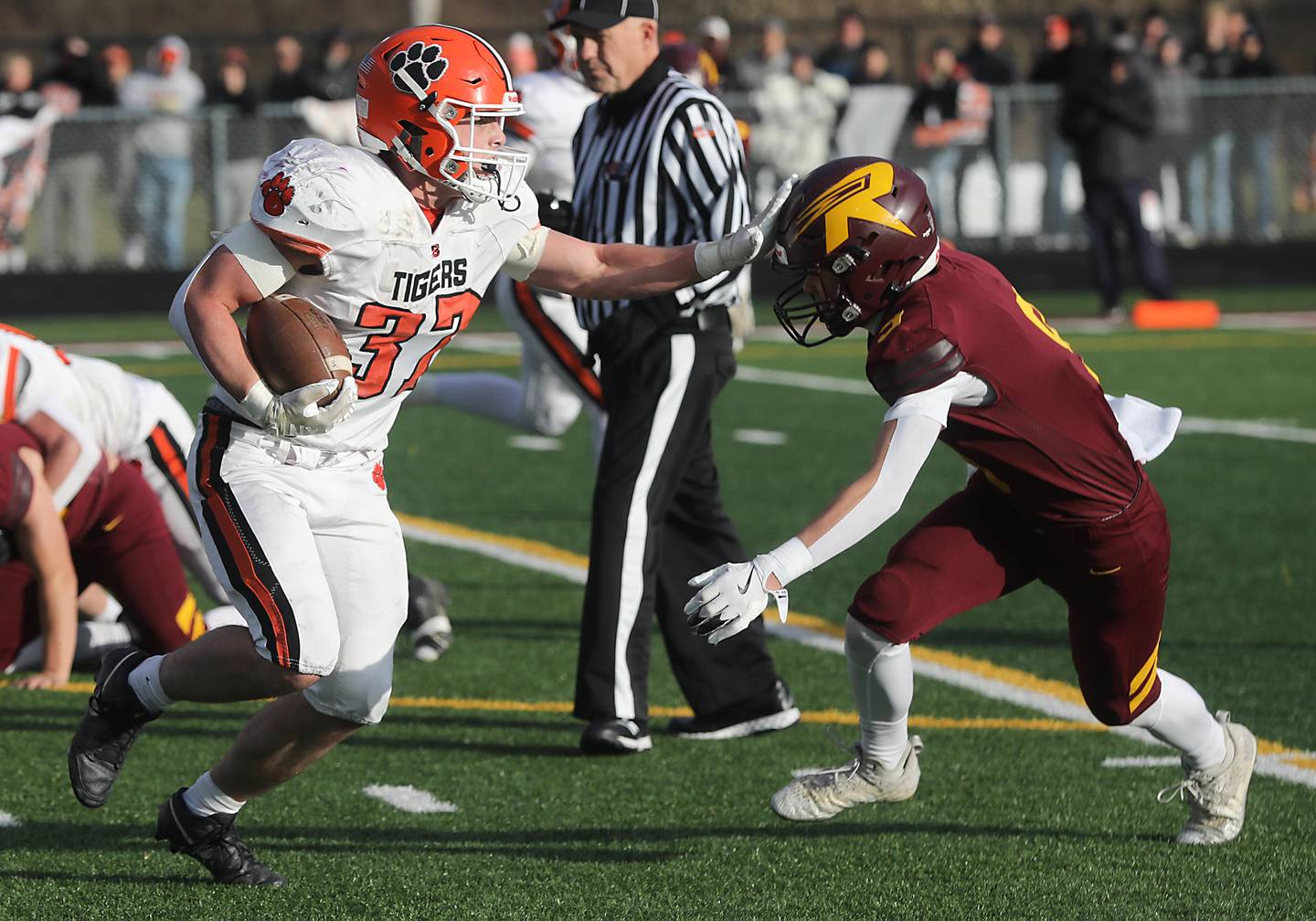 Byron’s Caden Considine stiff arms Richmond-Burton's Cooper Nagel as he runs with the football during an IHSA Class 3A semifinal playoff football game on Saturday, November 22, 2025, at Richmond-Burton High School, in Richmond.