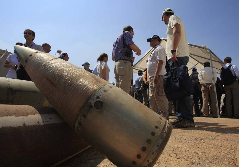 FILE - Activists and international delegations stand next to cluster bomb units, during a visit to a Lebanese military base at the opening of the Second Meeting of States Parties to the Convention on Cluster Munitions, in the southern town of Nabatiyeh, Lebanon, Sept. 12, 2011. The Biden administration has decided to provide cluster munitions to Ukraine and is expected to announce on Friday, July 6, 2023, that the Pentagon will send thousands as part of the latest military aid package for the war effort against Russia, according to people familiar with the decision. (AP Photo/Mohammed Zaatari, File)