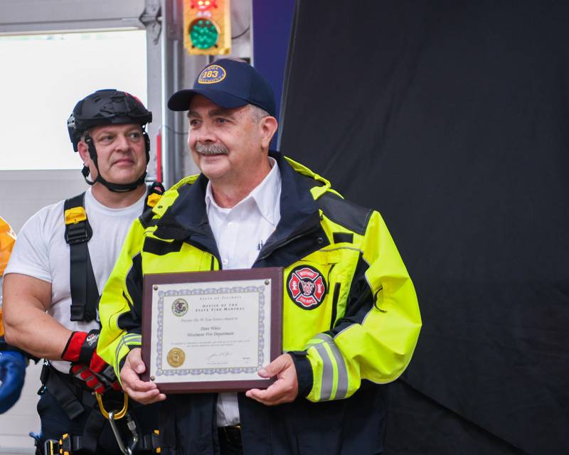 Dave Weiss poses for a photo after being presented a plaque for his 50 years of service with the Westmont fire department on Saturday Oct. 14, 2023, during the Westmont 100 year anniversary celebration fire department open house.