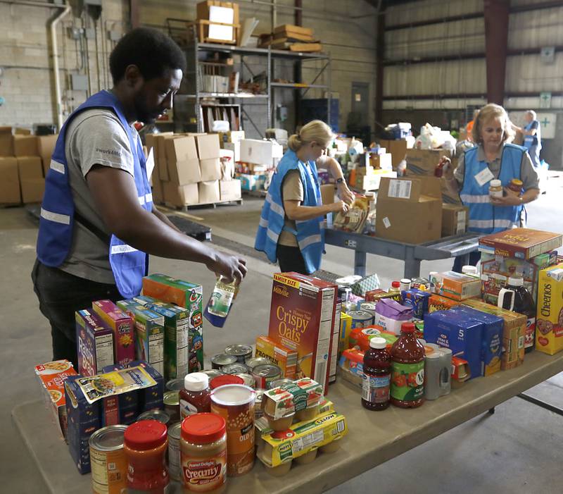 Trey Hunter, from the McHenry County Department of Health, and Arlene Ryndak and Sue Reinhardt, both volunteers from the McHenry County Medical Reserve Corp sort items during the Operation Dropbox Exercise on Tuesday , June 11, 2024, at the McHenry County Division of Transportation near Woodstock. The training exercise simulates the process of unloading and distributing medical counter-measures during emergencies along with helping to sort and distribute the donated items to veterans and their families in the county.