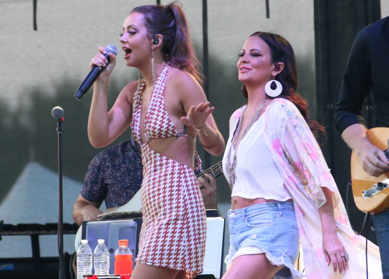 Sara Evans enters the stage as her daughter Olivia sings backup vocals on Thursday, Aug. 24, 2023 at the Bureau County Fair in Princeton.