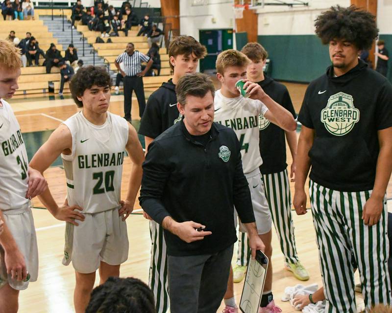 Glenbard West's head coach Jason Opoka talks to the team between quarters on Wednesday Nov. 26, 2025, while taking on Glenbard East during the District 87 Thanksgiving Invitational held at Glenbard West High School.