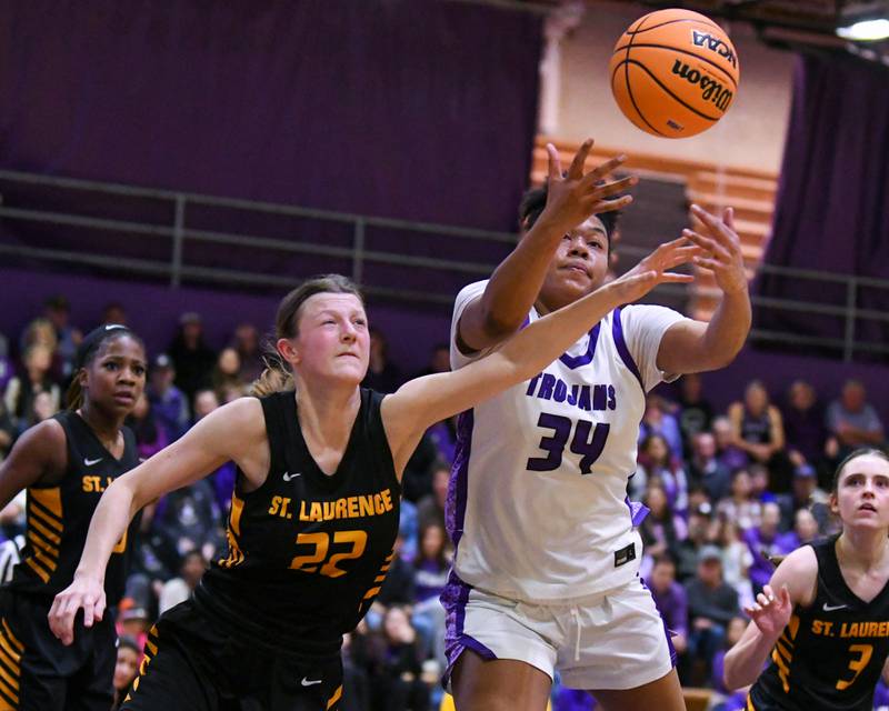 Downers Grove North's Elizabeth Murphy (34) and St. Laurence's Sara Burzycki (22) battle for a loose ball on Thursday Feb. 19, 2026, during the 4A regional championship game held at Downers Grove North High School.