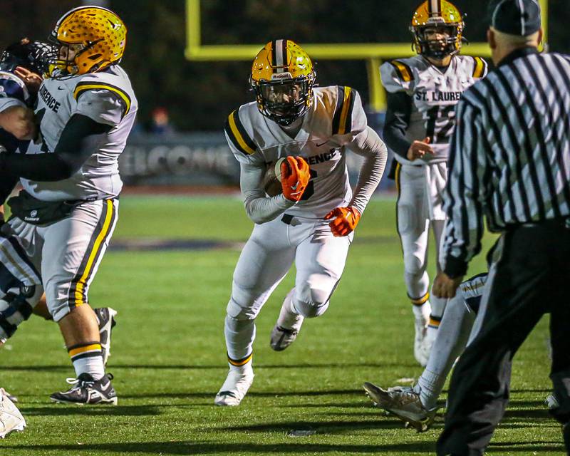 St Laurence's Aaron Ball (6) runs up the middle towards the goal lline during Class 4A third round playoff football game between St Laurence at IC Catholic Prep.  Nov 11, 2023.