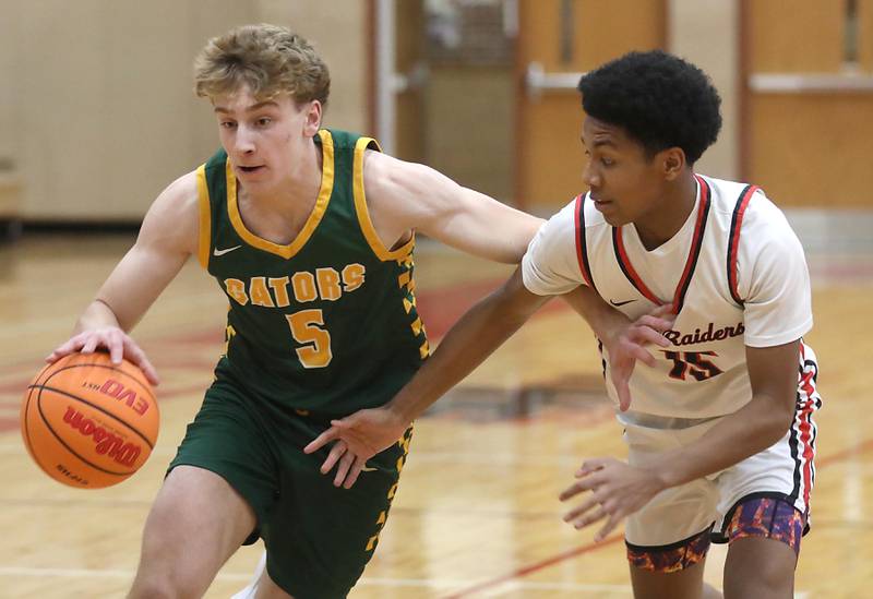 Crystal Lake South's Carson Trivellini tries to the basket against Huntley's Isaac Muze during a Fox Valley Conference boys basketball game on Wednesday, Dec. 10, 2025, at Huntley High School.