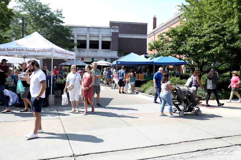 Shoppers browse the weekly farmer’s market in La Grange on Thursday, July 20, 2023.