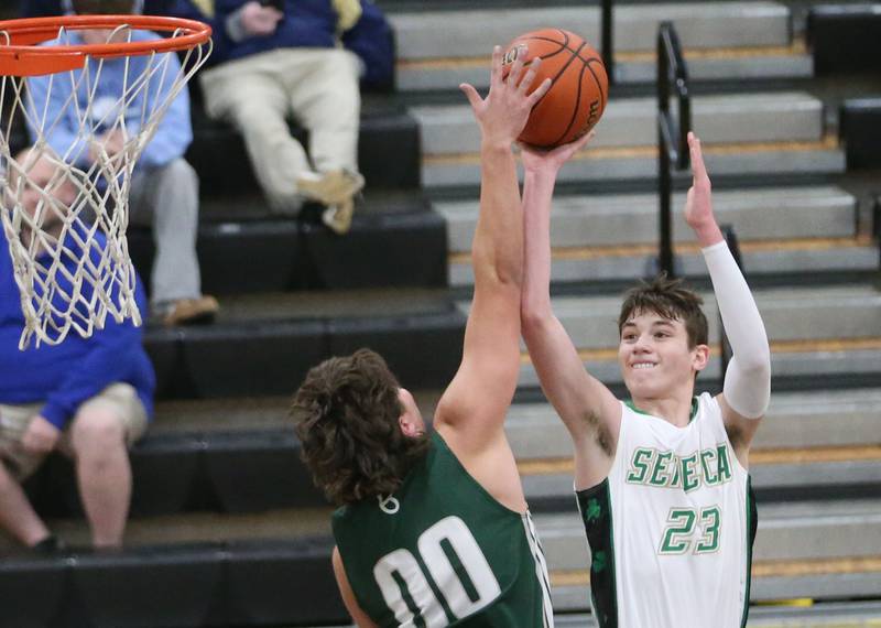 St. Bede's Nathan Husser reaches up to block a shot from Seneca's Brady Sheedy during the Tri-County Conference Tournament on Tuesday, Jan. 23, 2024 at Putnam County High School.