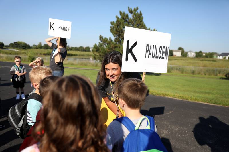 Kindergarten teacher Brooke Paulsen greets her students during the first day of school at Kaneland Blackberry Creek Elementary School in Elburn on Wednesday, Aug. 17, 2022