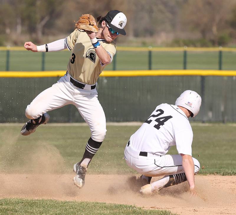 Sycamore's Hunter Britz takes the throw on a steal attempt by Kaneland's Johnny Spallasso during their game Thursday, May 4, 2023, at Kaneland High School.