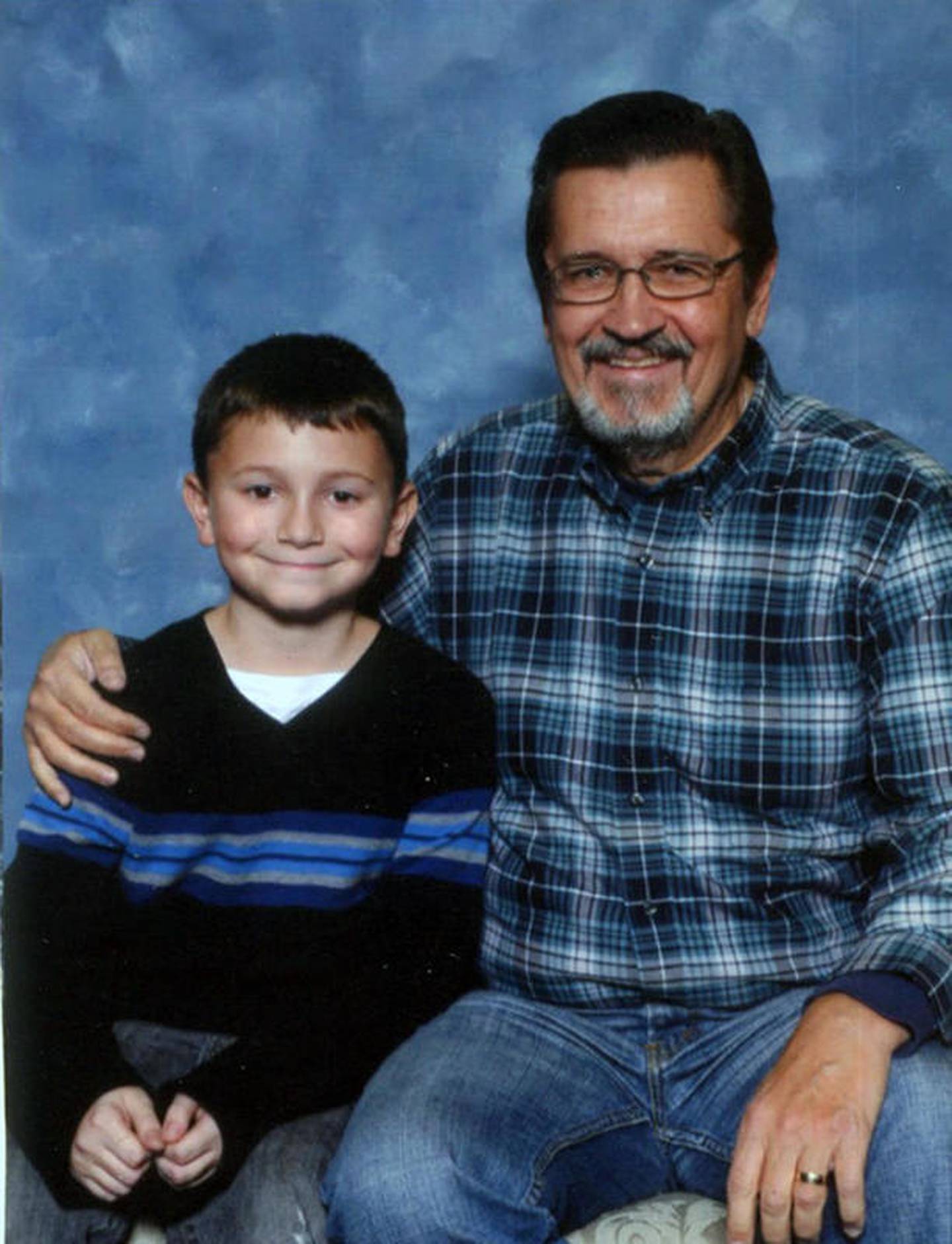 Dick Goss poses with his grandson Alex in Alex's younger years.