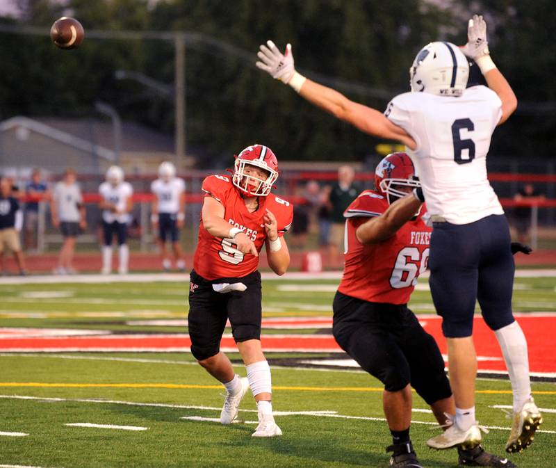 Yorkville quarterback Michael Dopart (9) tosses a pass against the New Trier defense during a varsity football game at Yorkville High School on Friday, Sep. 1, 2023.