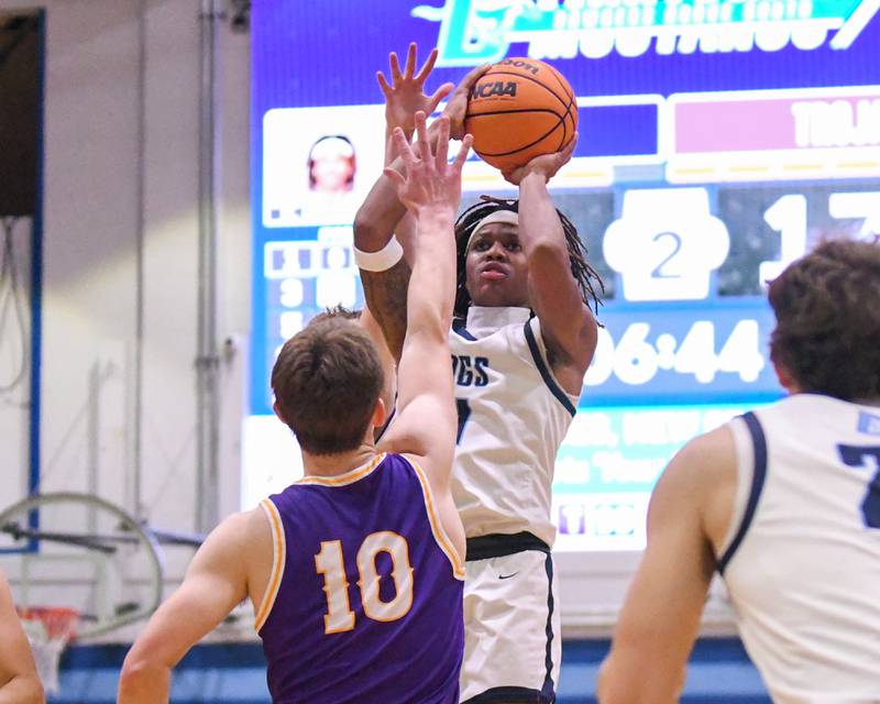 Downers Grove South's Keon Maggitt (1) takes a shot while being defended by Downers Grove North's Bobby Grganto (10) during the game on Saturday Dec. 21, 2024, held at Downers Grove South High School.