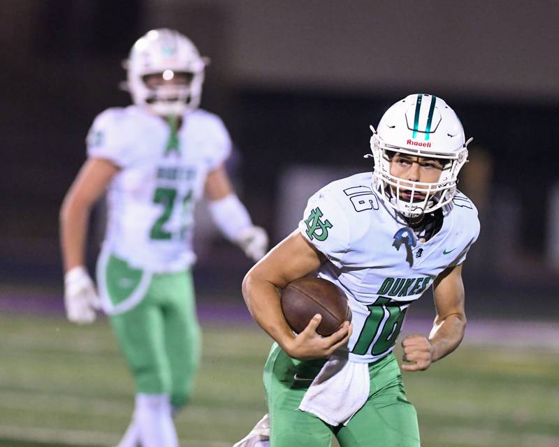 York's Zack Assaad (16) runs the ball during the game on Friday Oct. 10, 2025, while traveling to take on Downer Grove. North High School.