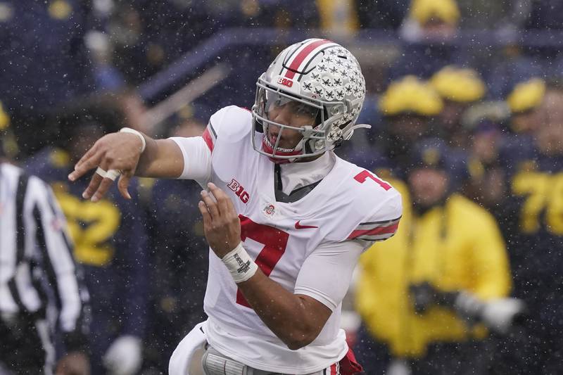 FILE - Ohio State quarterback C.J. Stroud throws during the first half of an NCAA college football game against Michigan, Saturday, Nov. 27, 2021, in Ann Arbor, Mich. The Fighting Irish open the season at No. 2 Ohio State, facing an offense that led the FBS in total yards and scoring last season and is only expected to improve in C.J. Stroud's second season as the starting quarterback. (AP Photo/Carlos Osorio, File)
