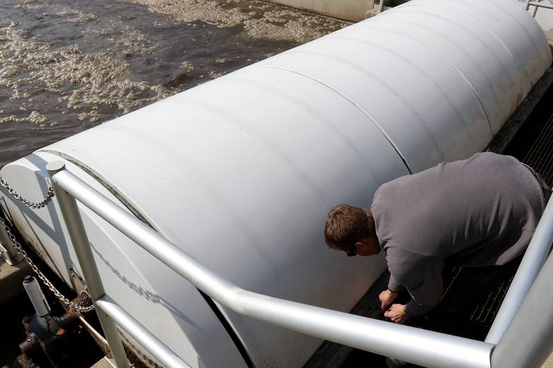 Northern Moraine Wastewater Reclamation District Superintendent Luke Markko opens a covered section in an aeration tank at the wastewater treatment plant on Thursday, April 22, 2021, in Island Lake. The district is attempting to build a sewer for the village of Holiday Hills.