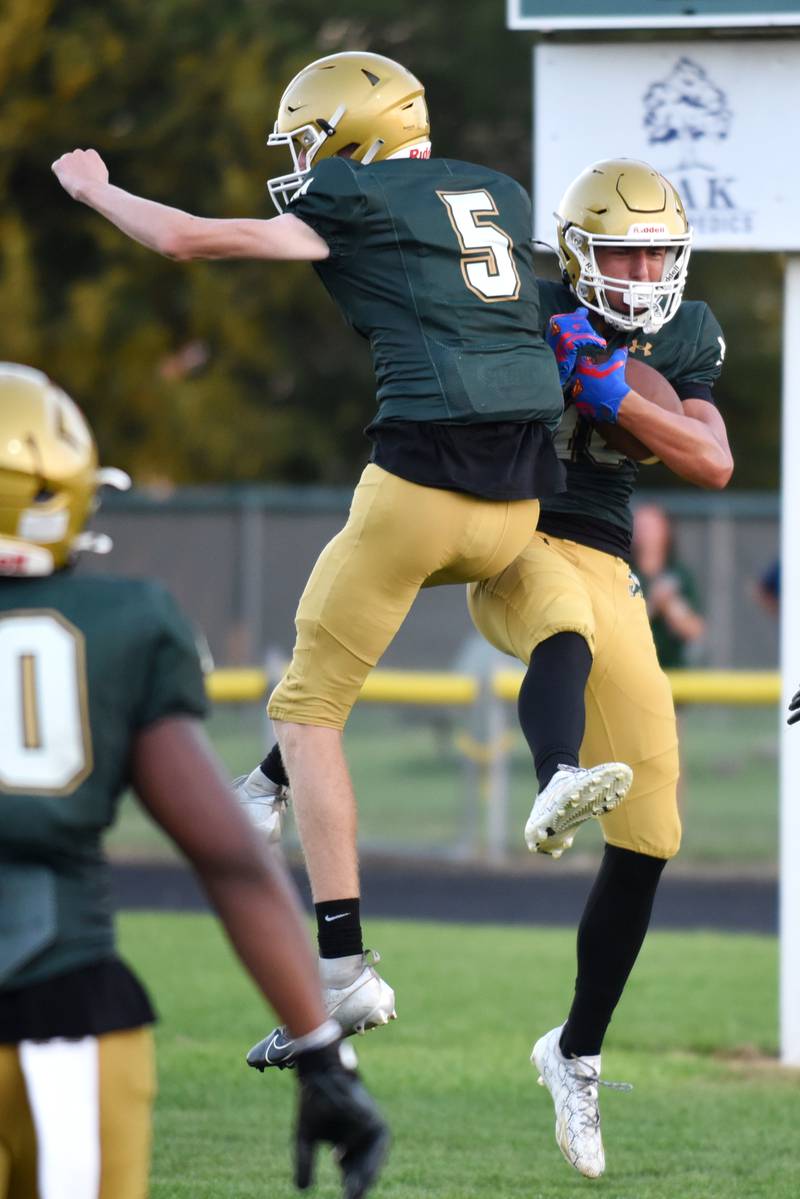 Bishop McNamara's Coen Demack, right, celebrates with Richie Darr after scoring a touchdown during a home Week 0 scrimmage against Streator Friday, Aug. 22, 2025.