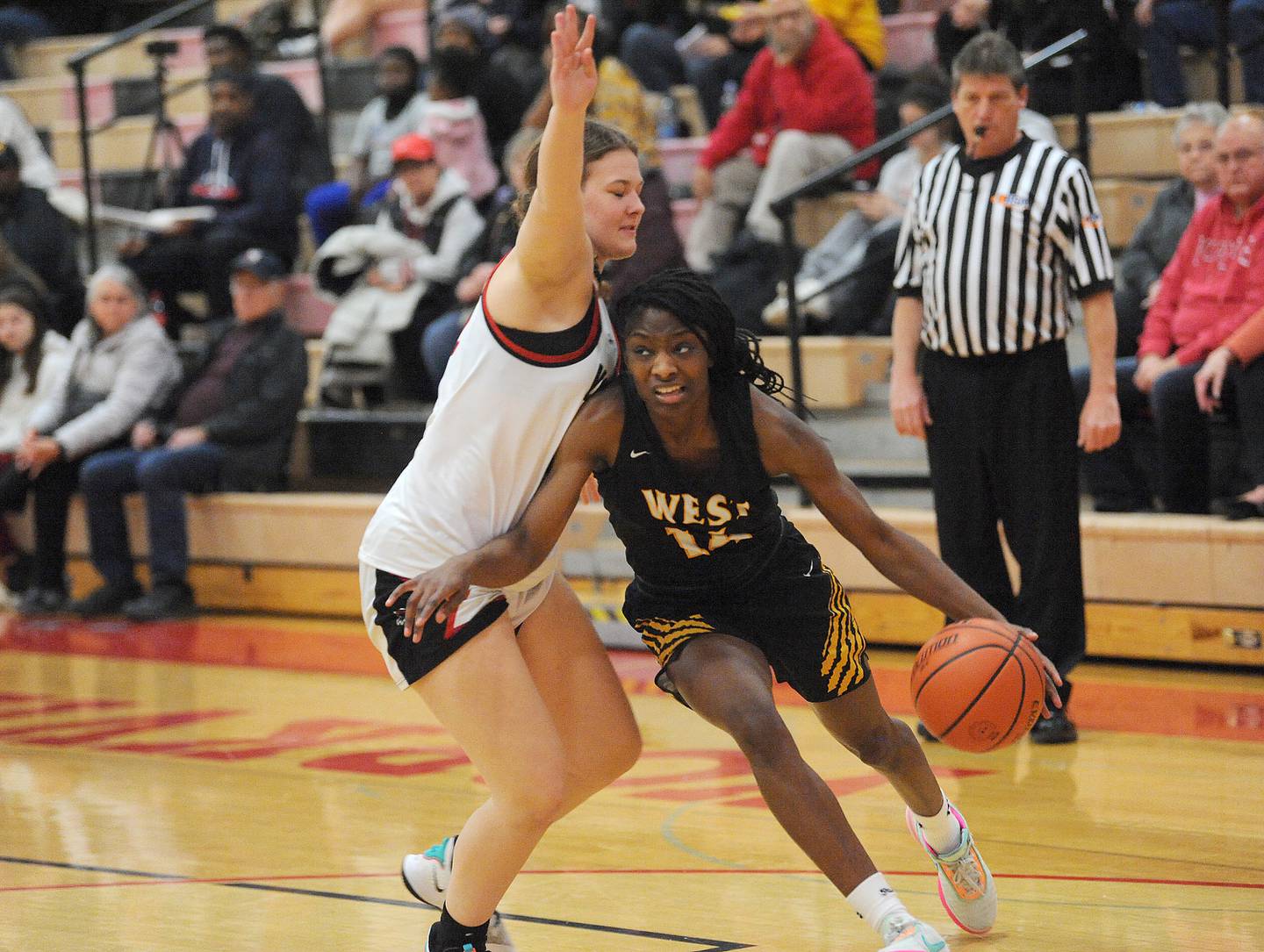 Joliet West's Destiny McNair (14) drives around Yorkville defender Ava Diqui during a girls' basketball game at Yorkville on Thursday, Jan. 19, 2023.