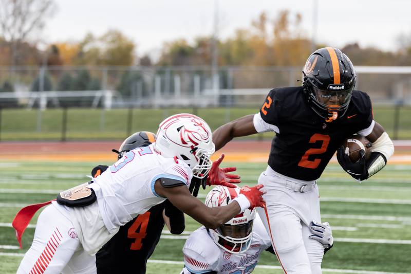 Lincoln-Way West's Jahan Abubakar attempts to evade Kenwood’s defense during a 7A varsity football playoff game at Lincoln-Way West on Nov. 8, 2025.