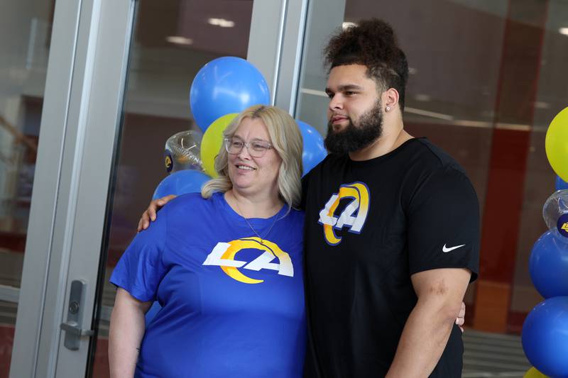 Keagen Trost, a 2019 Kankakee High School grad, takes a photo with his mom, Shannon Trost, during a celebration held for him at the school on May 4, 2026, following him being drafted into the NFL to the Los Angeles Rams.