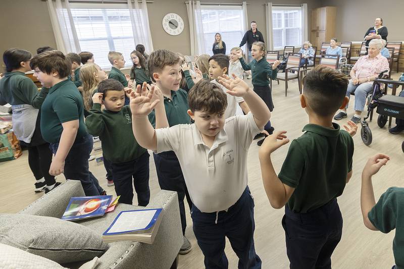 St. Andrew’s first through third grade students act out a song for residents Thursday, Jan. 30, 2025, at Morningside of Sterling. The senior living facility was one of two facilities the school visited as part of their community outreach.