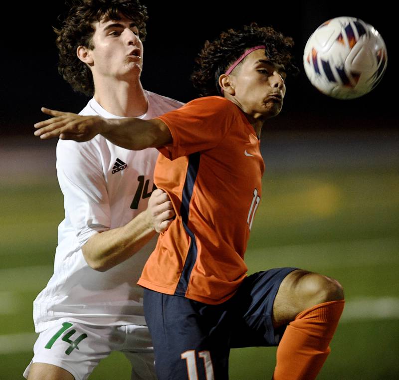 Romeoville’s Luis Orizaba and York’s Drew Ebner compete late in overtime in the Class 3A semifinal game of the boys state soccer tournament in Hoffman Estates on Friday, November, 4, 2022.