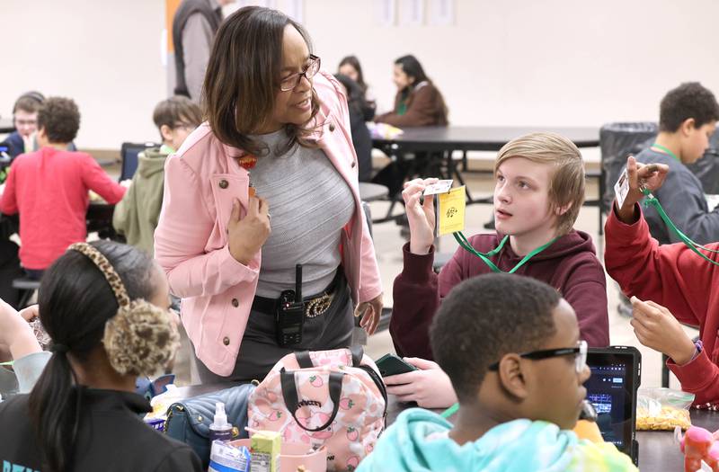 Treveda Redmond, principal at Huntley Middle School, makes sure that sixth-grade students are all wearing their ID’s Tuesday, March 14, 2023, at the school in DeKalb.