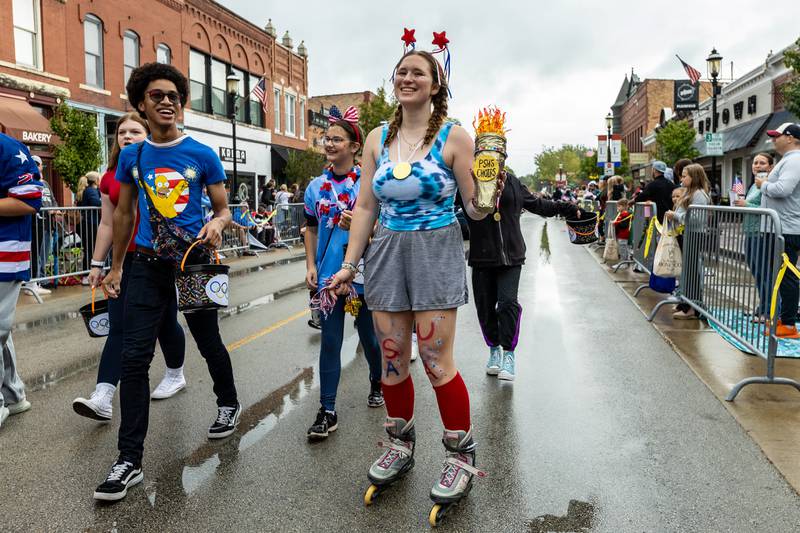 Senior Allie Beintum rollerblades with the Plainfield South High School Choir Boosters during the Plainfield Community Homecoming Parade on Sept. 28, 2024.