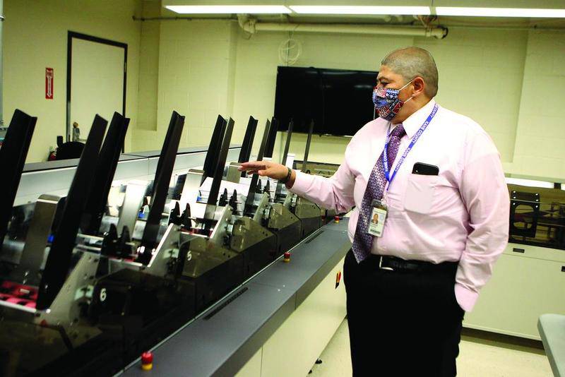 Raymond Esquivel, Kane County director of elections, gives a demonstration of how the office plans to handle an influx of mail-in ballots for the Nov. 3 general election.