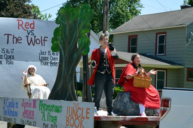 Members of the Polo Area Community Theater dressed up from their play, "Red vs. The Wolf," wave to onlookers during the Polo Town & Country Days parade on June 19, 2022.