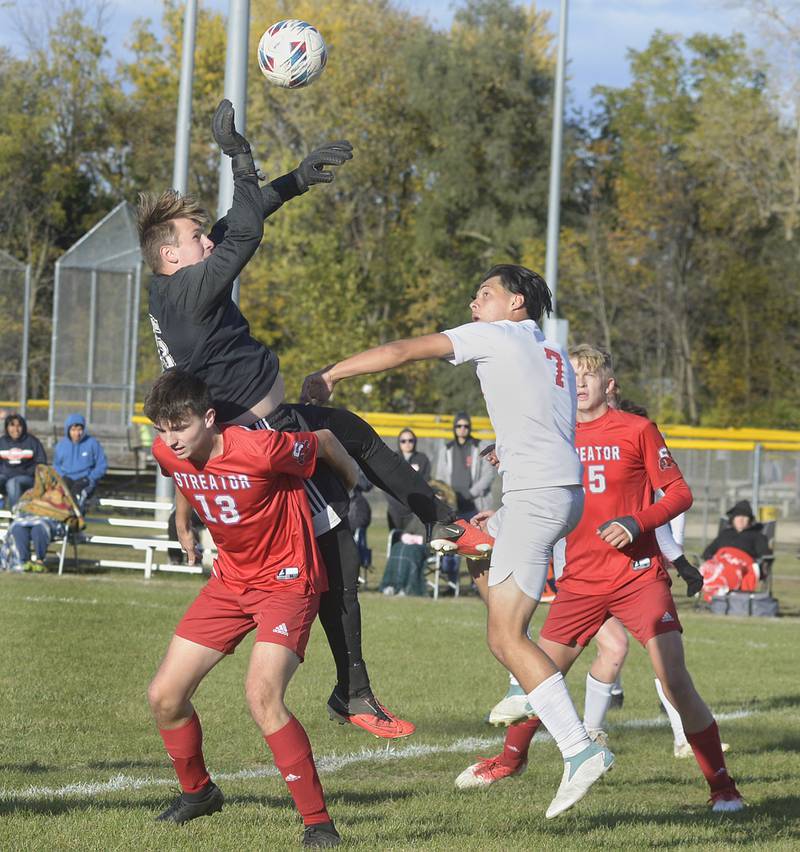 Streator’s Aaron Henson helps team mate goalkeeper Andrew Vogel make a save against Ottawa’s Jorge Lopez in the 1st half Tuesday at Streator.